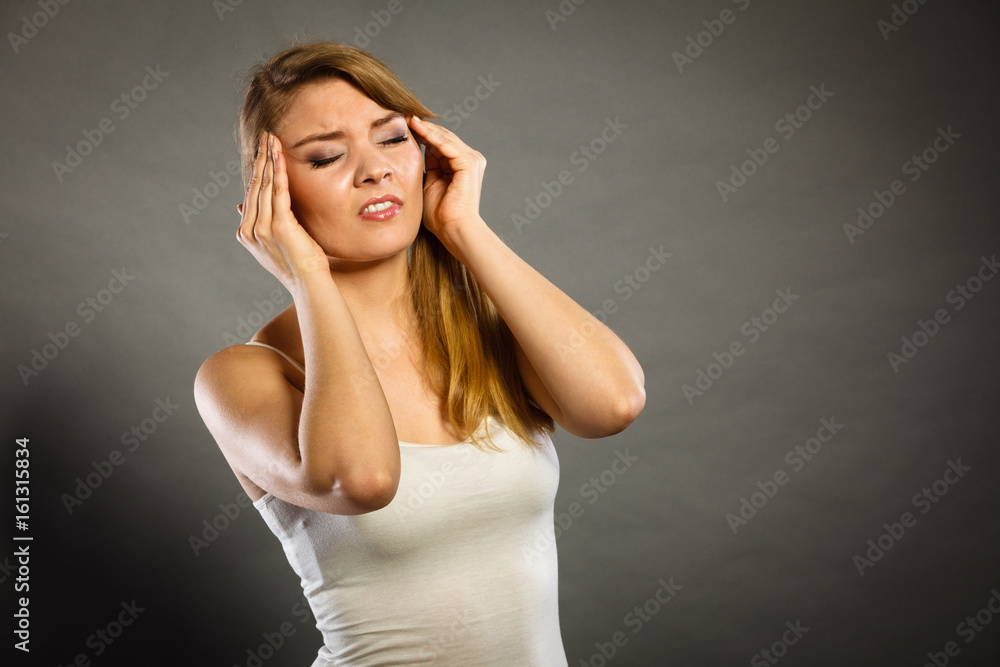 Woman suffering from headache migraine pain.