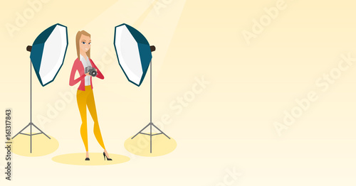 Photographer with a camera in a photo studio.