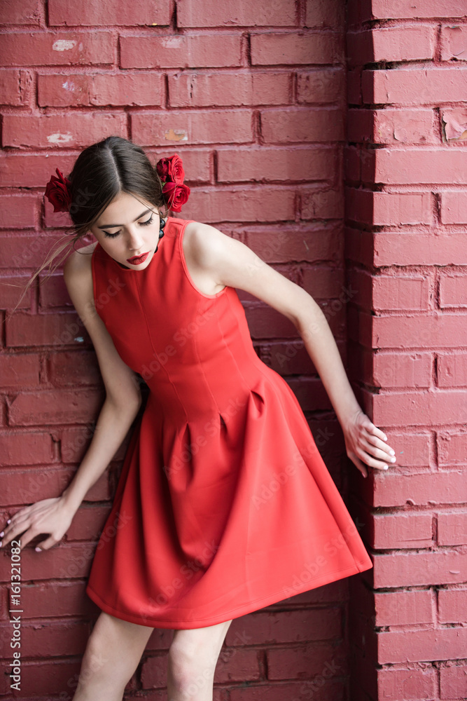 spanish woman with fashionable makeup and rose flower in hair