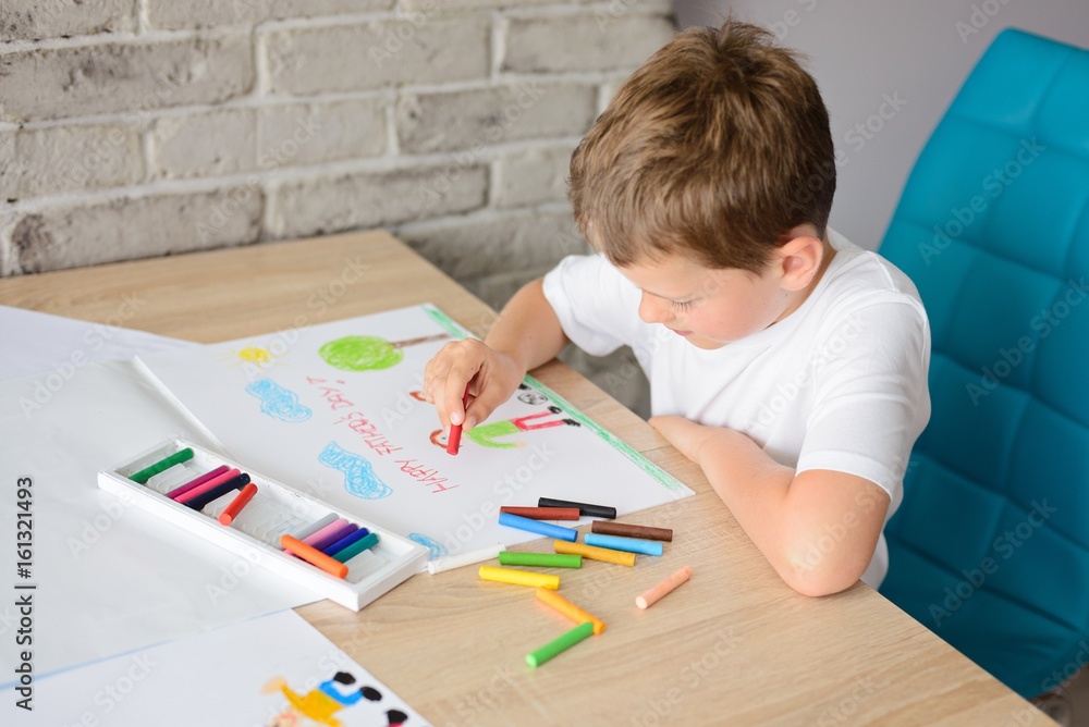 Child drawing a card for daddy Child drawing a card for daddy