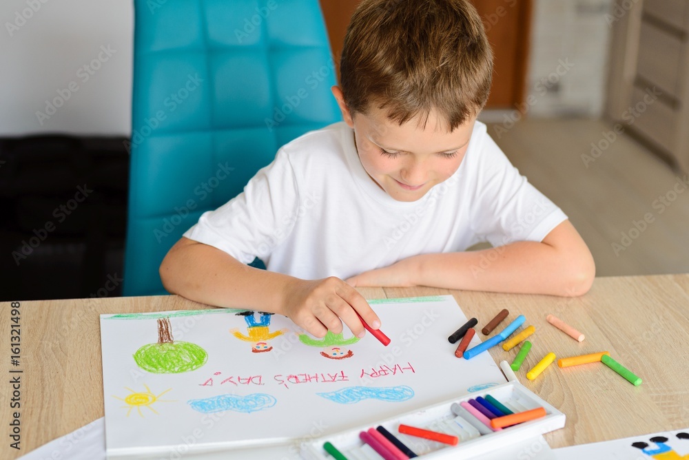 Child drawing a card for daddy Child drawing a card for daddy