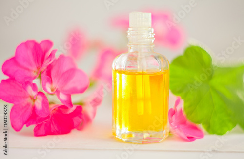 Essence of flowers on table in beautiful glass jar