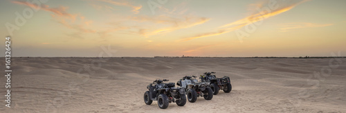 group of four wheels drive cycles in Sahara desert in Tunisia