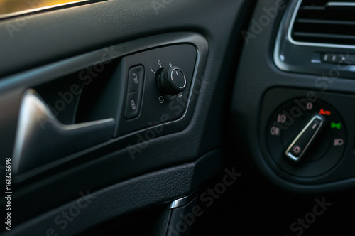 Car interior: door, handle,mirror control.