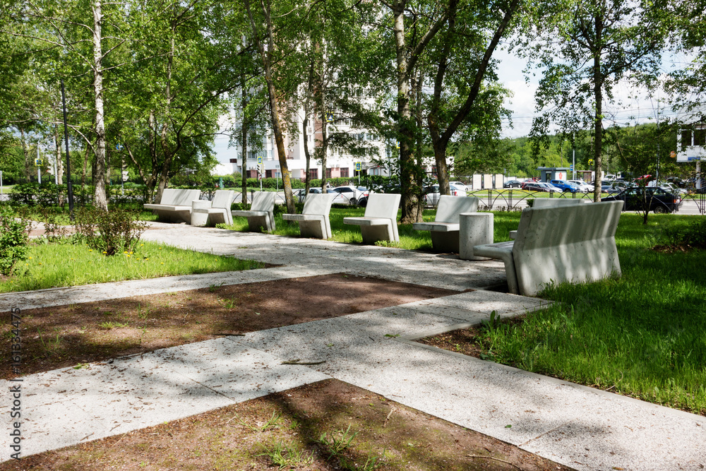 Modern concrete benches and path in a public park.