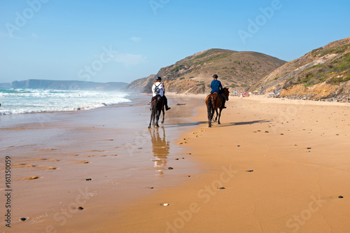 Horse riding at the beach at the atlantic ocean