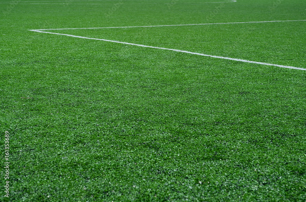 Fototapeta premium football field with artificial turf with white diagonal lines, background