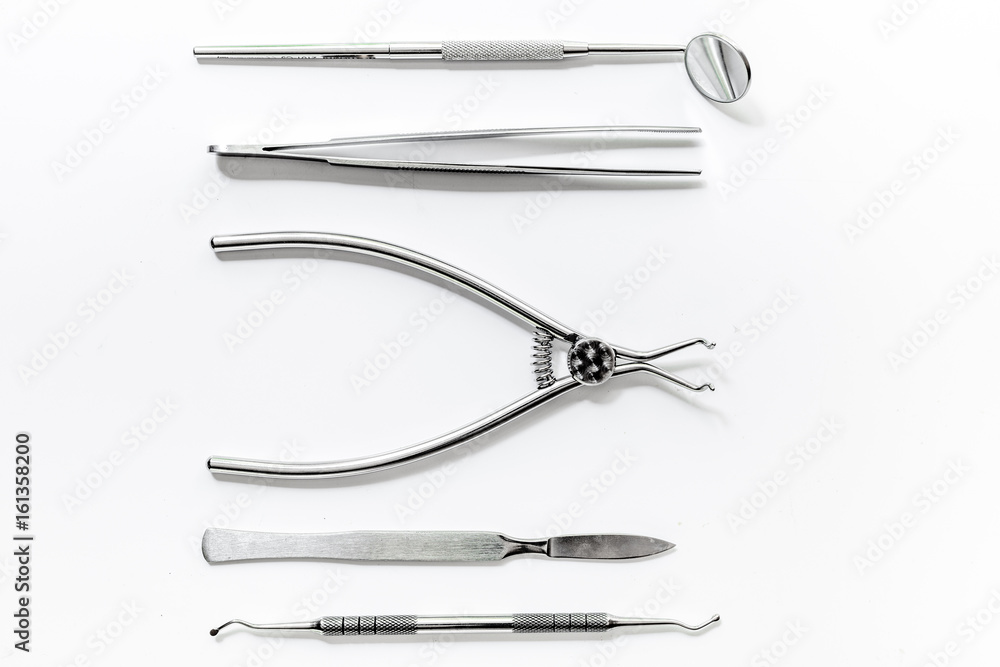 teeth care with dentist instruments in doctor's office white background top view