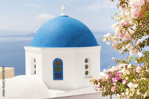 Church with blue dome and purple flowers 