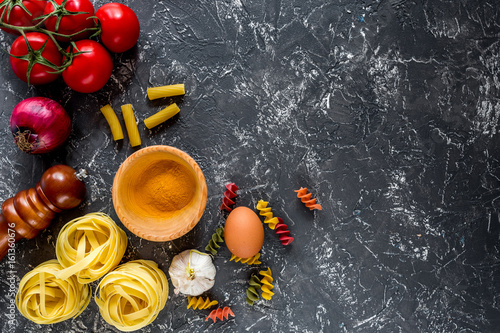 Italian food concept pasta ingredients on grey stone desk background top view copyspace