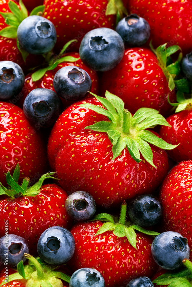 Closeup Macro of Tasty Ripe Red Strawberry with Fresh Blue Berries. Pile Hipe of Summer Berries Fruits. Summer Healthy Food Concept. Closeup Macro of Tasty Ripe Red Strawberry with Fresh Blue Berries. Pile Hipe of Summer Berries Fruits. Summer Healthy Food Concept.