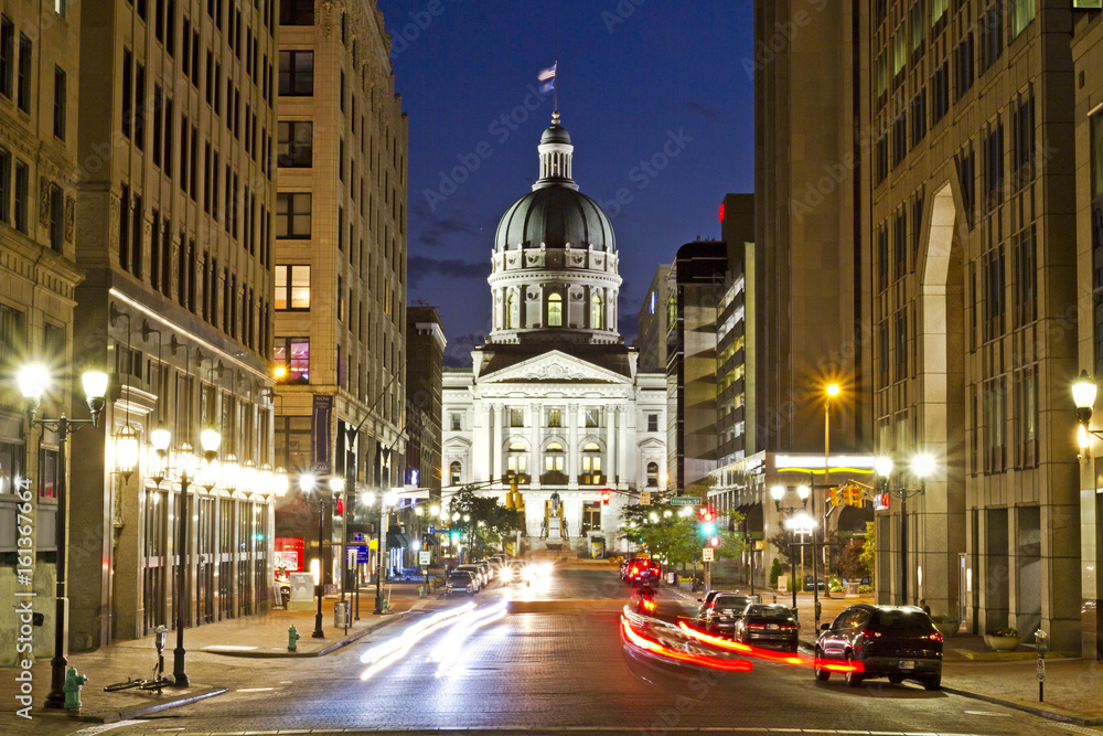 Indiana statehouse at night with busy streets and nightlife