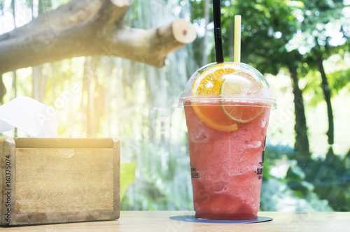 Strawberry smoothie on wood table in the garden. photo