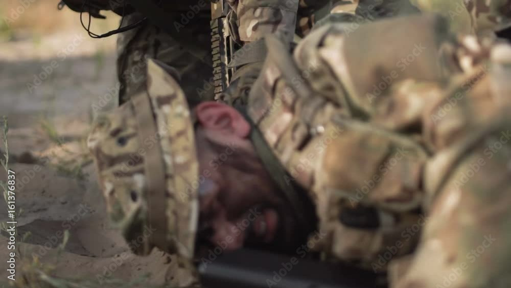 The soldier saves getting injured while shooting and having contact on battlefield. The soldier saves getting injured while shooting and having contact on battlefield.