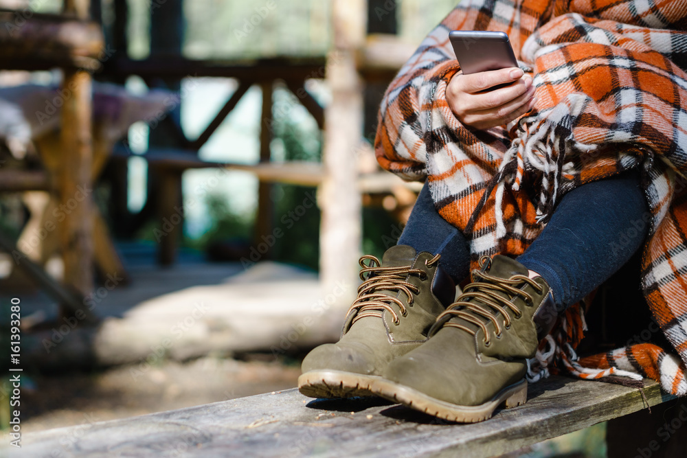 Woman using Smartphone in the woods. Woman using Smartphone in the woods.