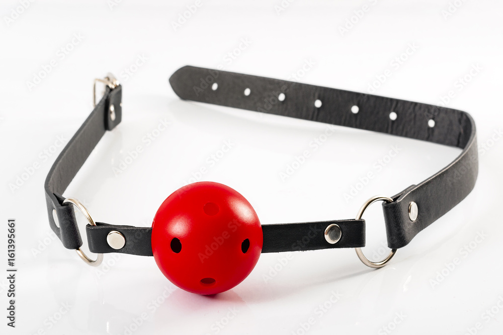 Fetish and kinky sex play and BDSM sex toys concept with a red ball gag toy  isolated on white Stock Photo | Adobe Stock
