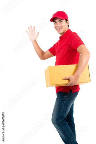 Smiling delivery man making hi (or bye) gesture while holding box in another hand
