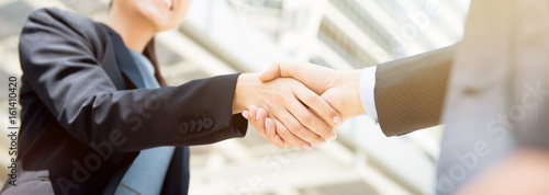 Businesswoman making handshake with a businessman, female leader concept