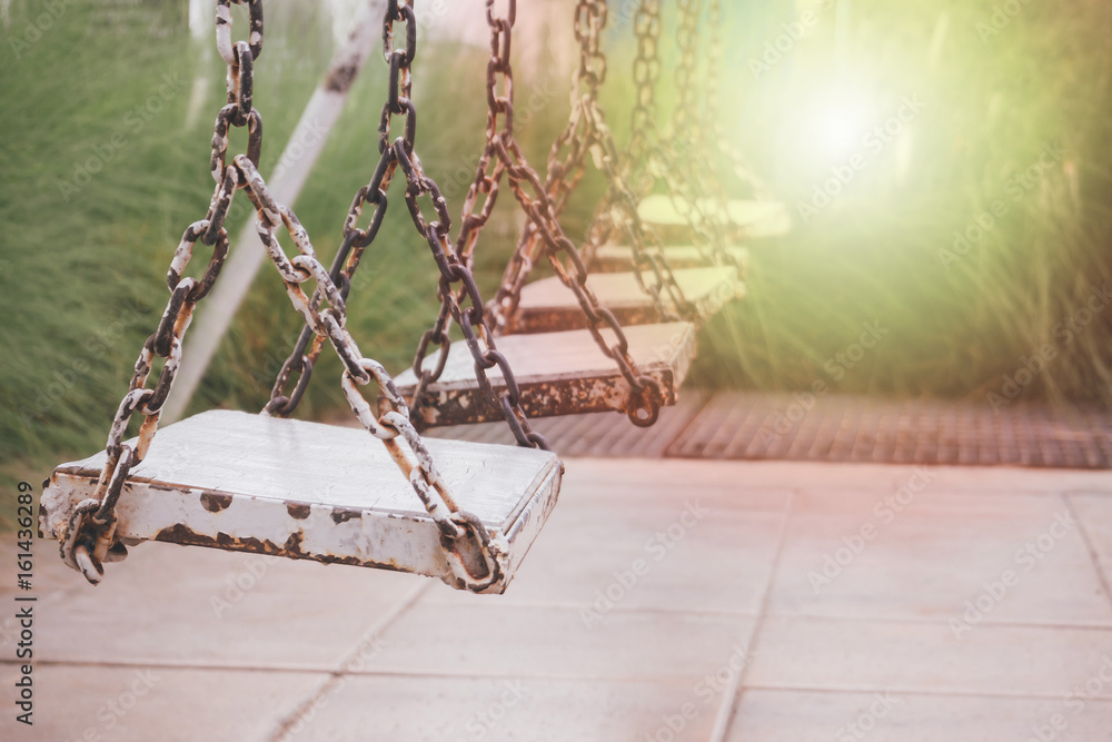 old wood swing in playground park old wood swing in playground park