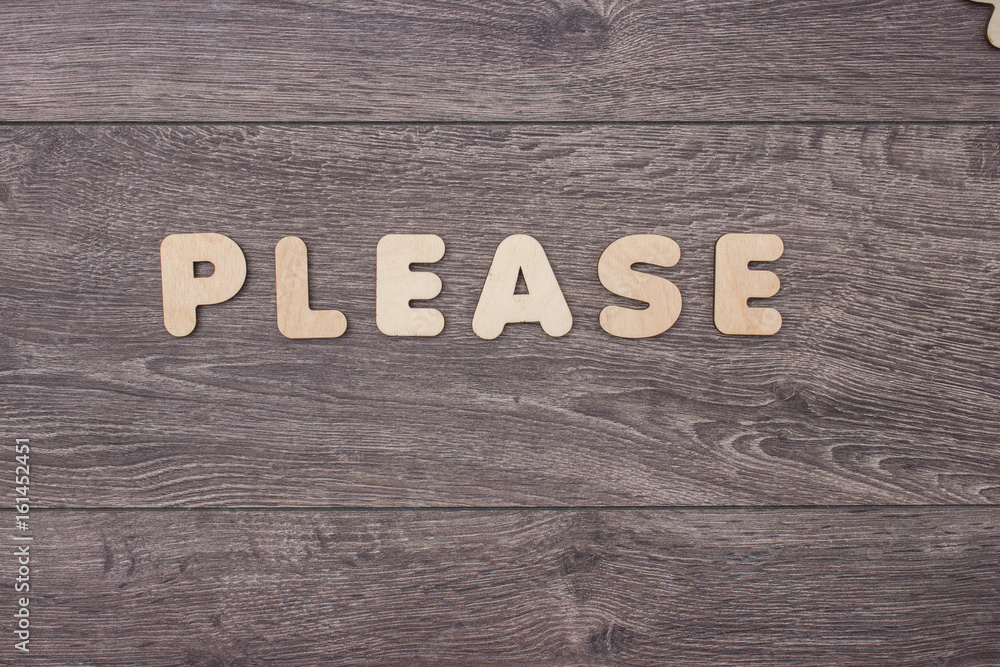 Word made with wooden letters next to a pile of other letters over the wooden board Word made with wooden letters next to a pile of other letters over the wooden board