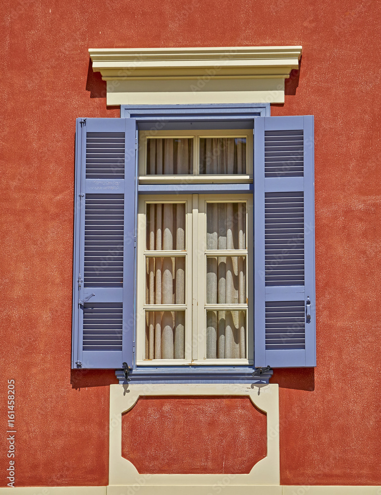 Fototapeta premium elegant vintage window on orange house wall