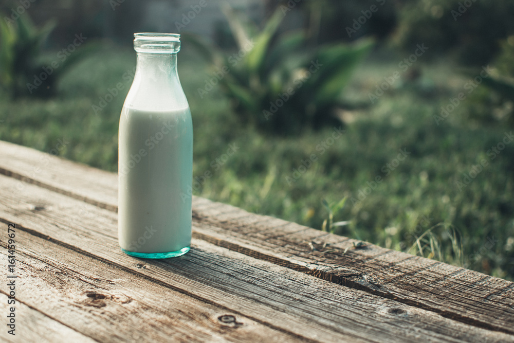 Bottle of fresh milk and glass on a wooden table Bottle of fresh milk and glass on a wooden table