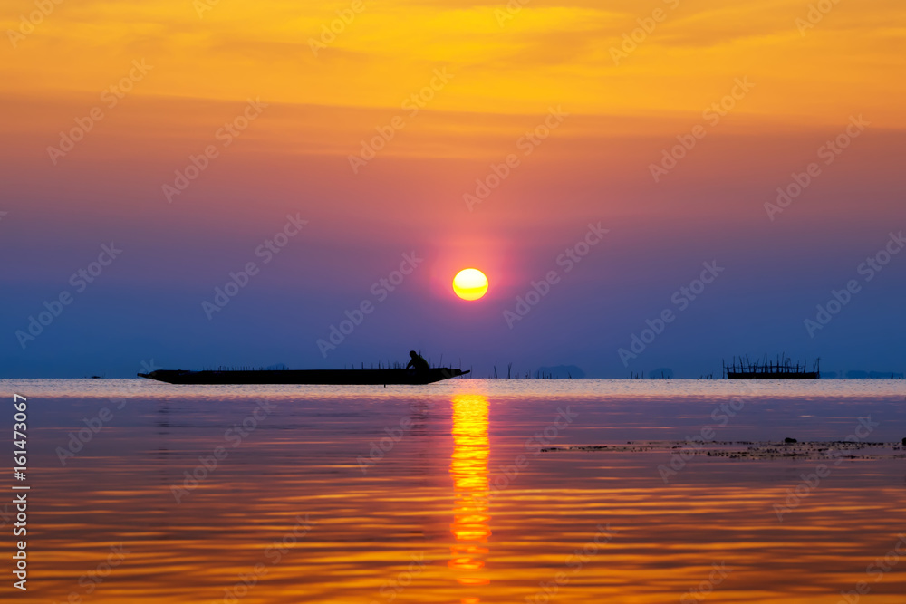 Silhouette fisherman and Sunset sky on the lake in south of Thailand. Silhouette fisherman and Sunset sky on the lake in south of Thailand.
