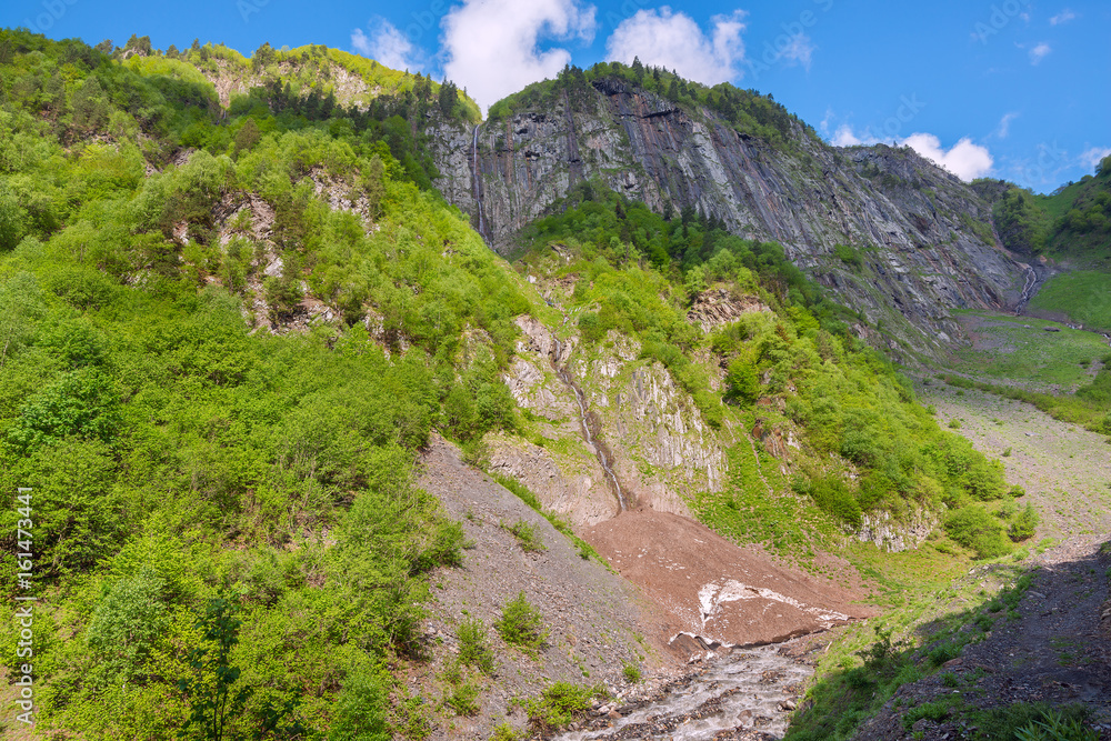 Beautiful waterfalls on a rocky mountain slope