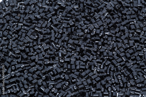 Obraz na płótnie Black plastic polymer granules on white background