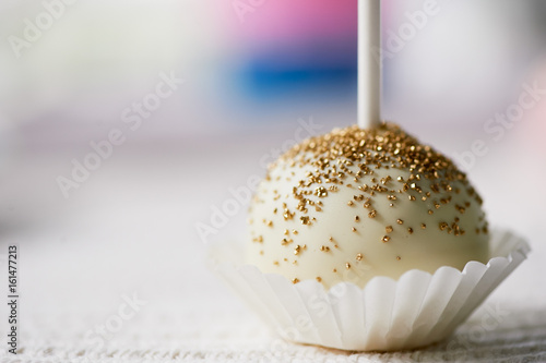 Wallpaper Mural cake pop on a stick on a wooden background. Beautiful candy pastel shades Torontodigital.ca