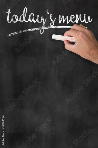 Obraz na plátně hand holding a piece of chalk after writing the words TODAYS MENU onto a blackbo