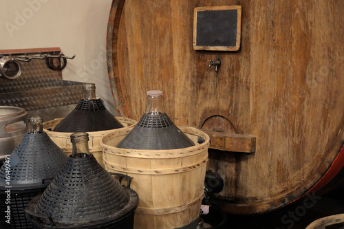 Wine bottles and barrels in wnery