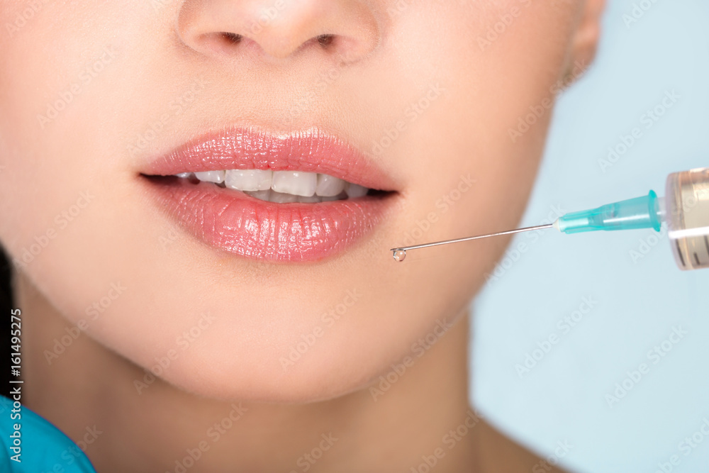 Woman mouth and syringe