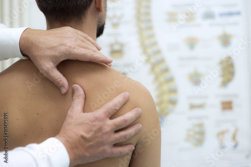Medical check at the shoulder in a physiotherapy center photo