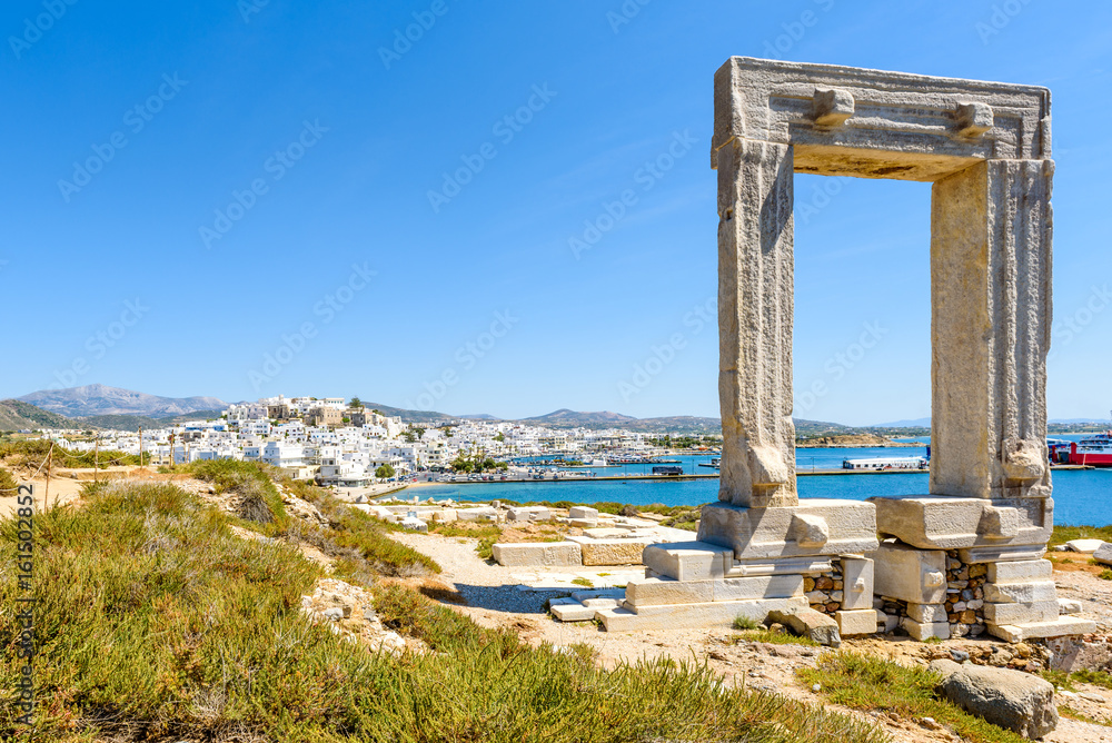 The Portara, one of Naxos most famous landmarks connected to Naxos (Chora) town by a causeway. Cyclades Islands, Greece.