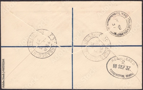 Stamp printed in Barbados shows The reverse side of the postal envelope of a registered letter with a variety of postmark, circa 1937 photo