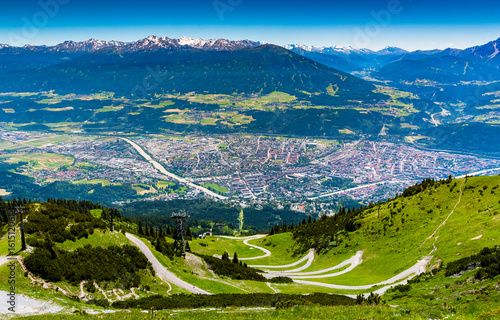 view from above of Innsbruck city with alpes mountain range, Natural path and Cable car take from Nordkette mountain photo