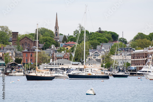 Newport Harbor in Newport, Rhode Island. The brown steeple is the historic St. Mary's Church where John F. Kennedy was married. Sailboats and moorings are in the foreground. Seaside, coastal town photo