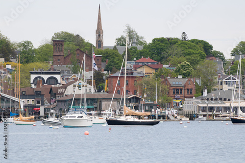 Newport Harbor in Newport, Rhode Island. The brown steeple is the historic St. Mary's Church where John F. Kennedy was married. Sailboats and moorings are in the foreground. Seaside, coastal town photo