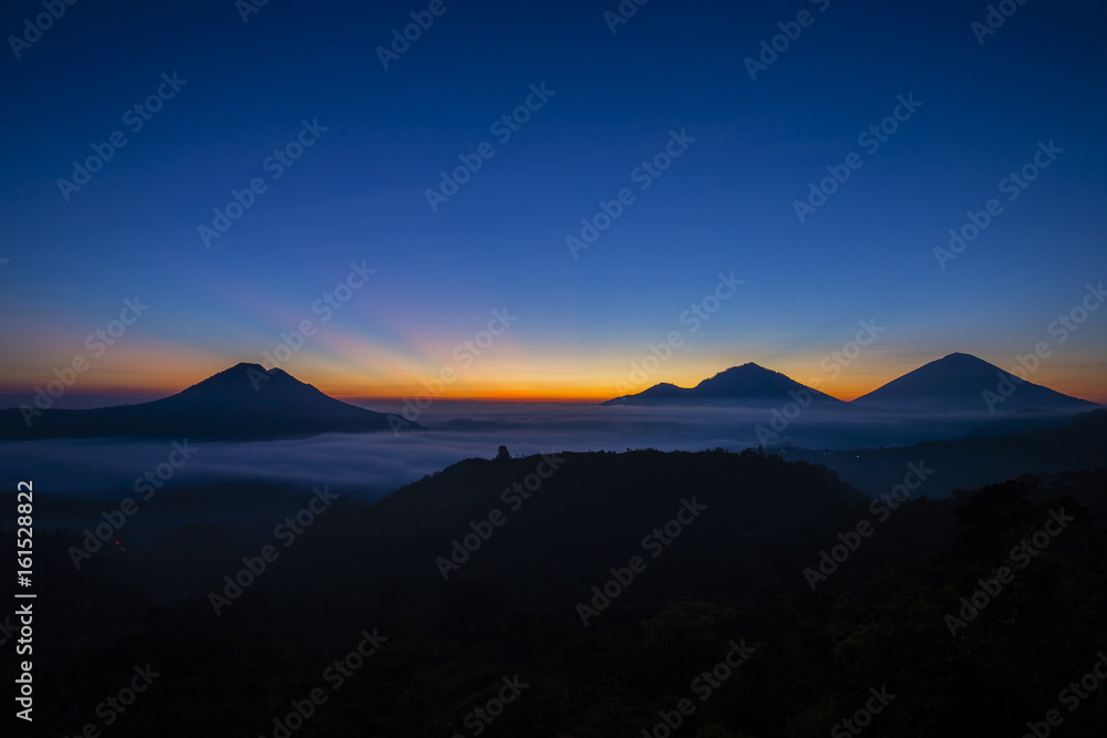 Scenic sunrise and mist at Batur volcano, Kintamani, Bali, Indonesia.
