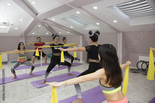 Tire Pilates Class girls and man in pilates studio photo