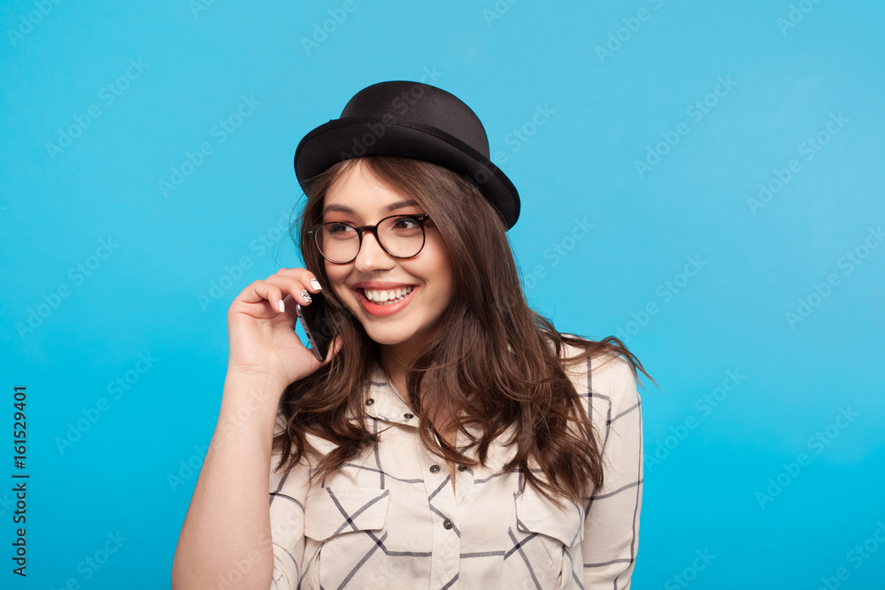 Stylish model talking phone in studio Stylish model talking phone in studio