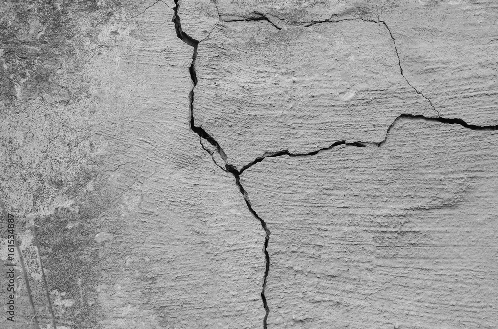 Fototapeta premium Gray old cracked wall with concrete divorces. vintage texture.