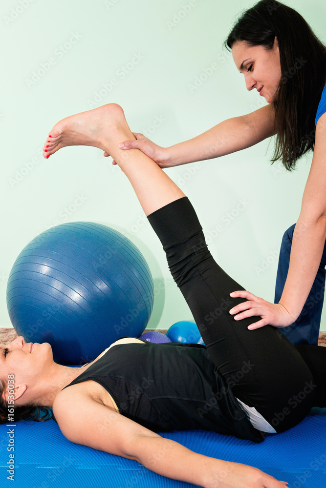 Fototapeta premium Physical therapist working with female athlete
