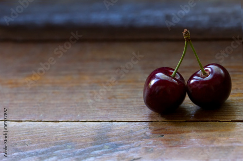  ripe red cherries on a wooden table