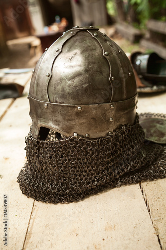 Modern copy of antique metal knight helmet with aventail. Historical medieval costume detail