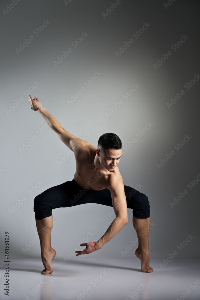 Young and stylish modern ballet dancer on grey background Young and stylish modern ballet dancer on grey background