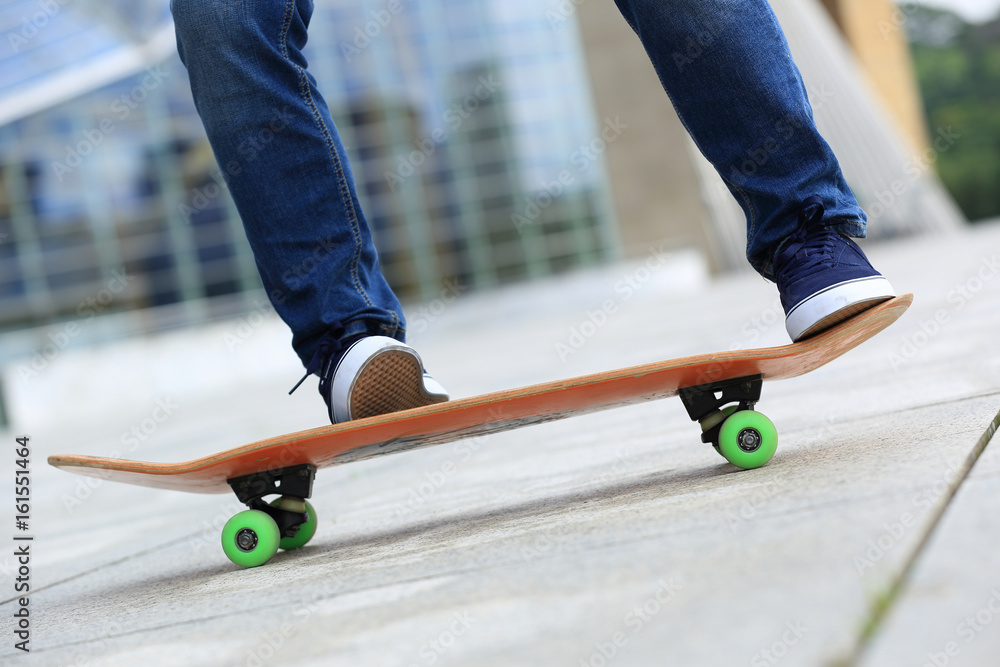 Skateboarder legs skateboarding at city Skateboarder legs skateboarding at city