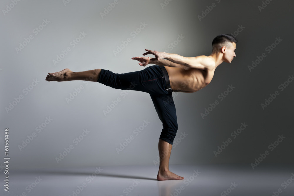 Obraz premium Young and stylish modern ballet dancer on grey background