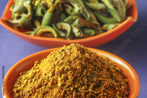 close up of indian achar masala with dry mango  slice in bowl